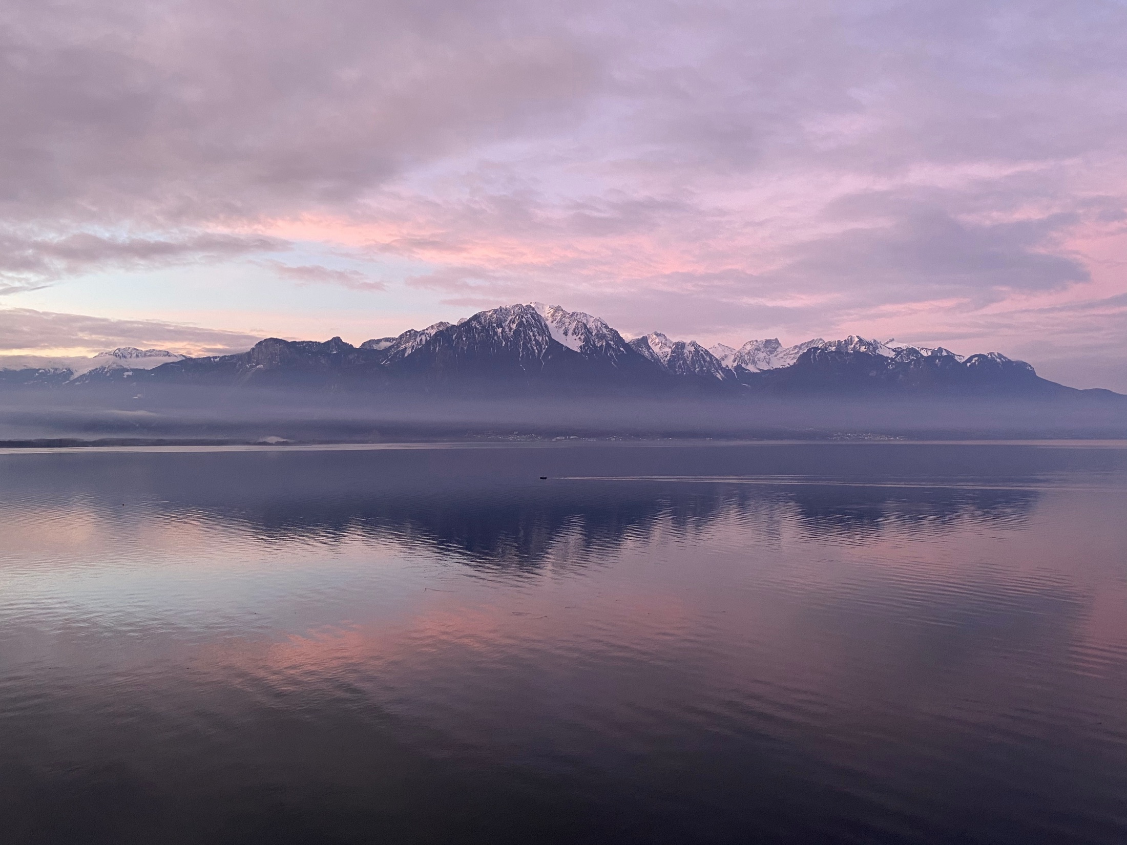 Pink cotton-candy winter sky over Lake Geneva and the mountains near Montreux