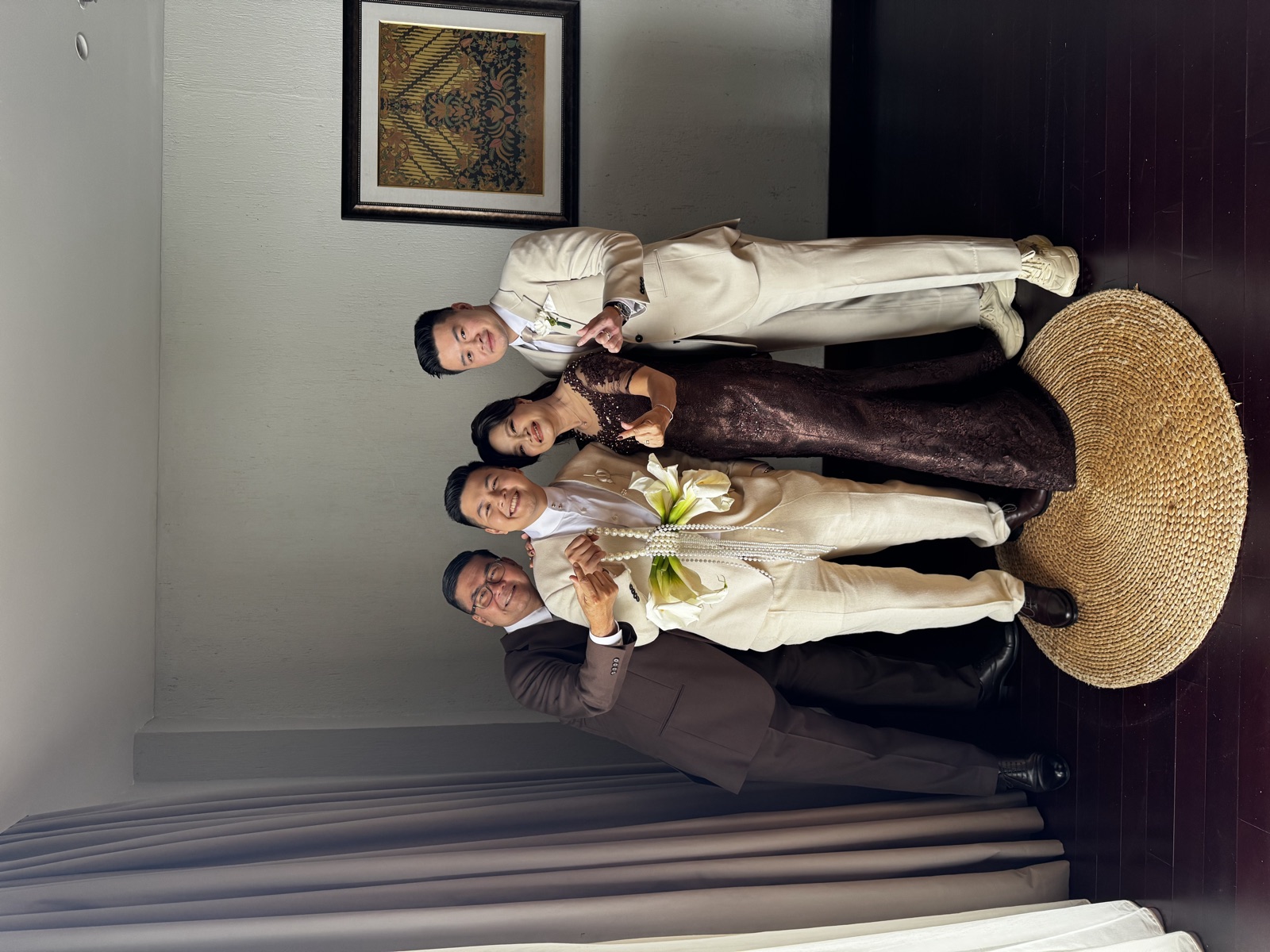 Family posing with the groom before the wedding ceremony