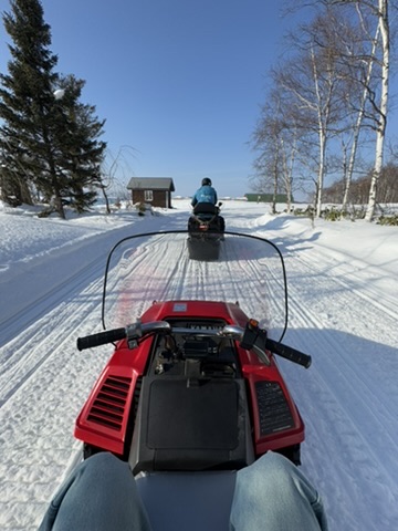 Point-of-view photo from a snow ATV ride in Biei