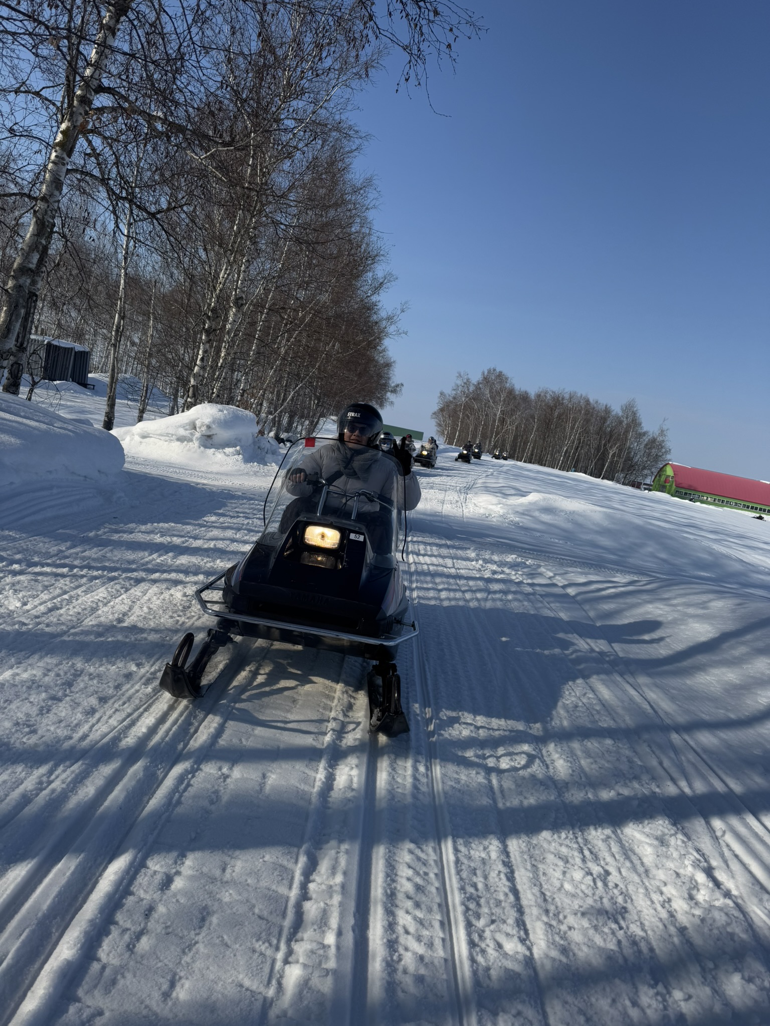 Snow ATV riding on a snowy Biei trail