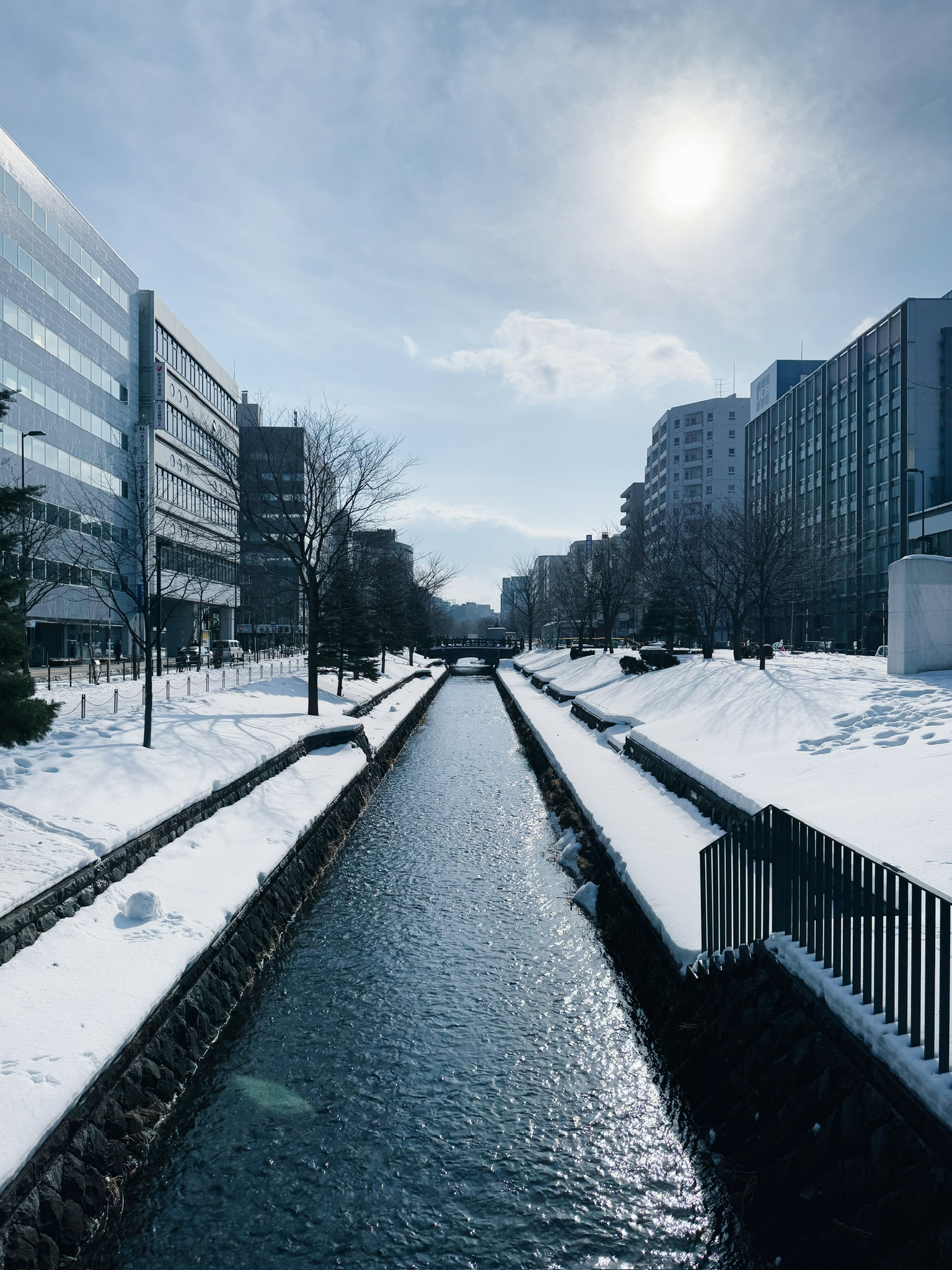 Snowy canal near Odori Park on a sunny winter day