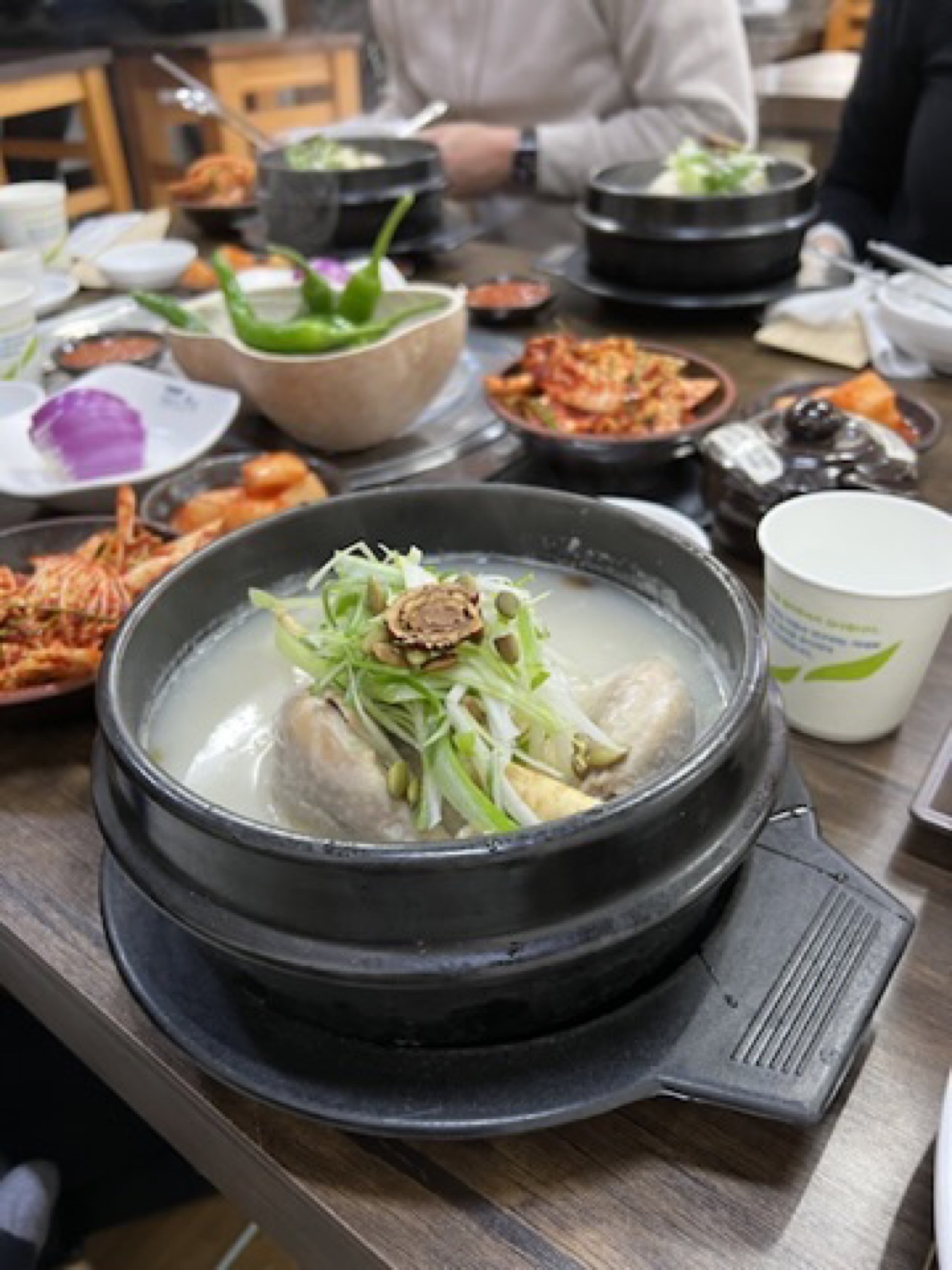 Warm Korean pork soup lunch in Busan with side dishes