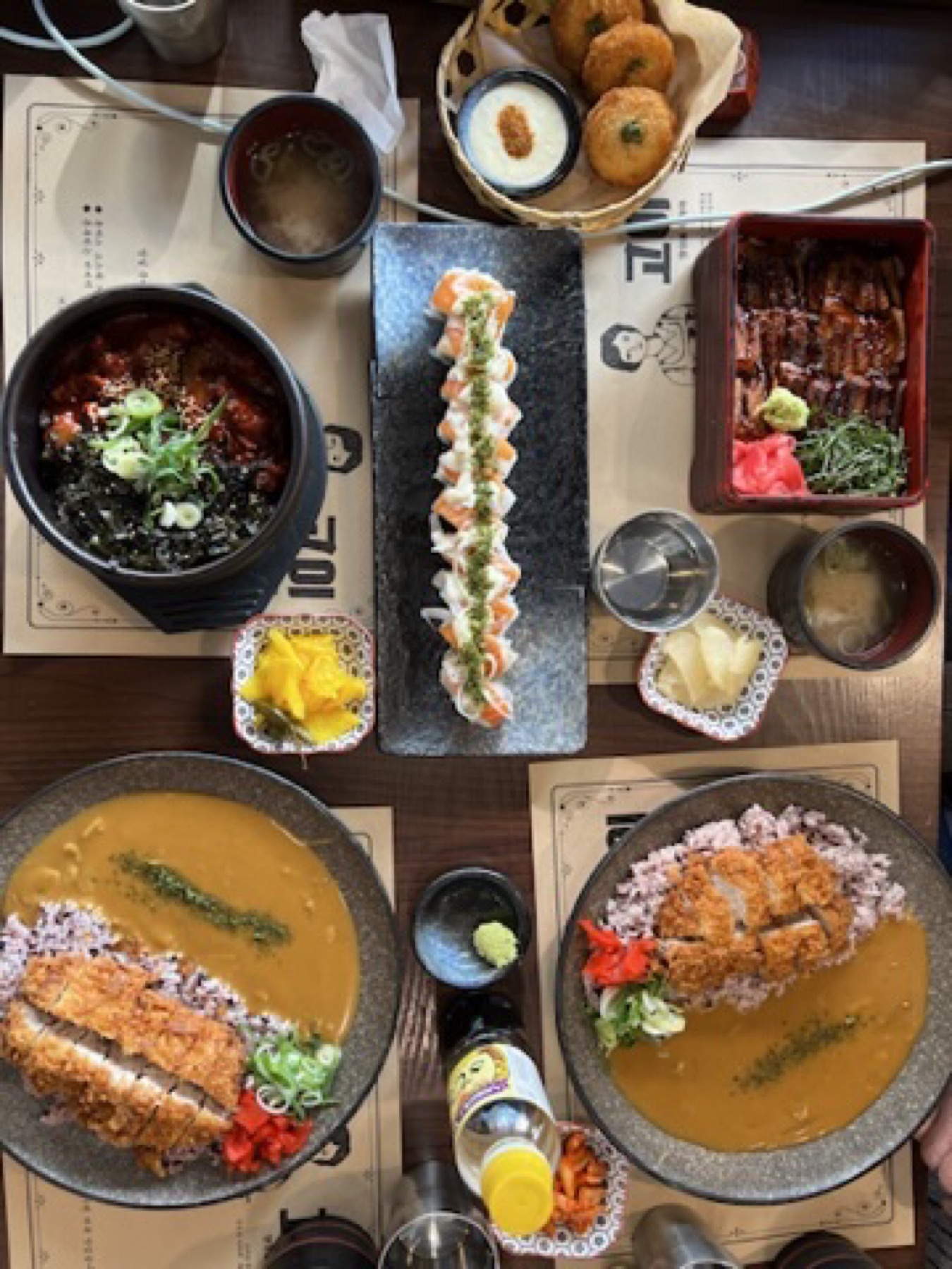 Busan meal spread with seafood, rice, soup, and multiple side dishes