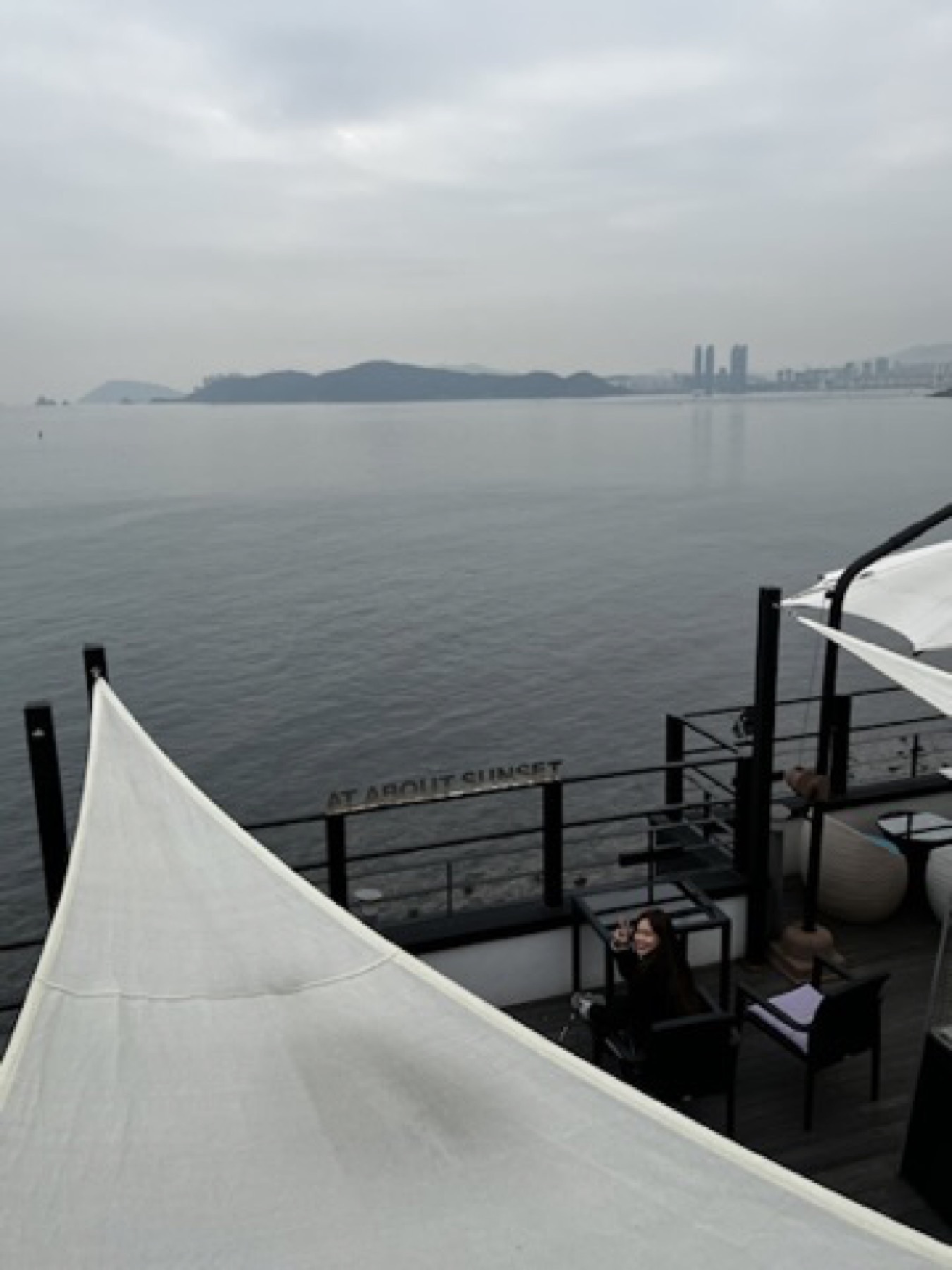 Seaside cafe view in Busan looking across calm grey water