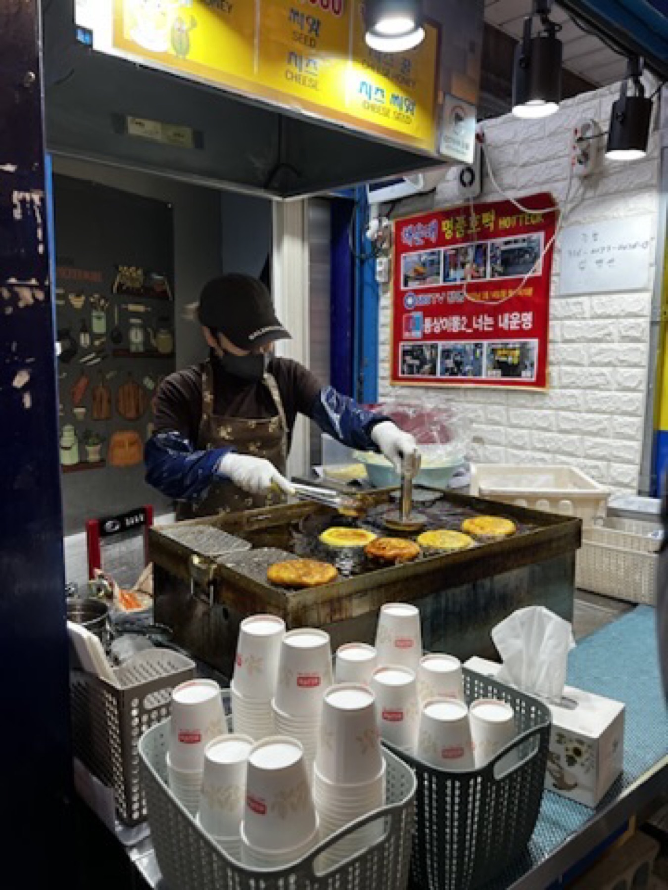 Street vendor cooking round snacks on a griddle in Busan