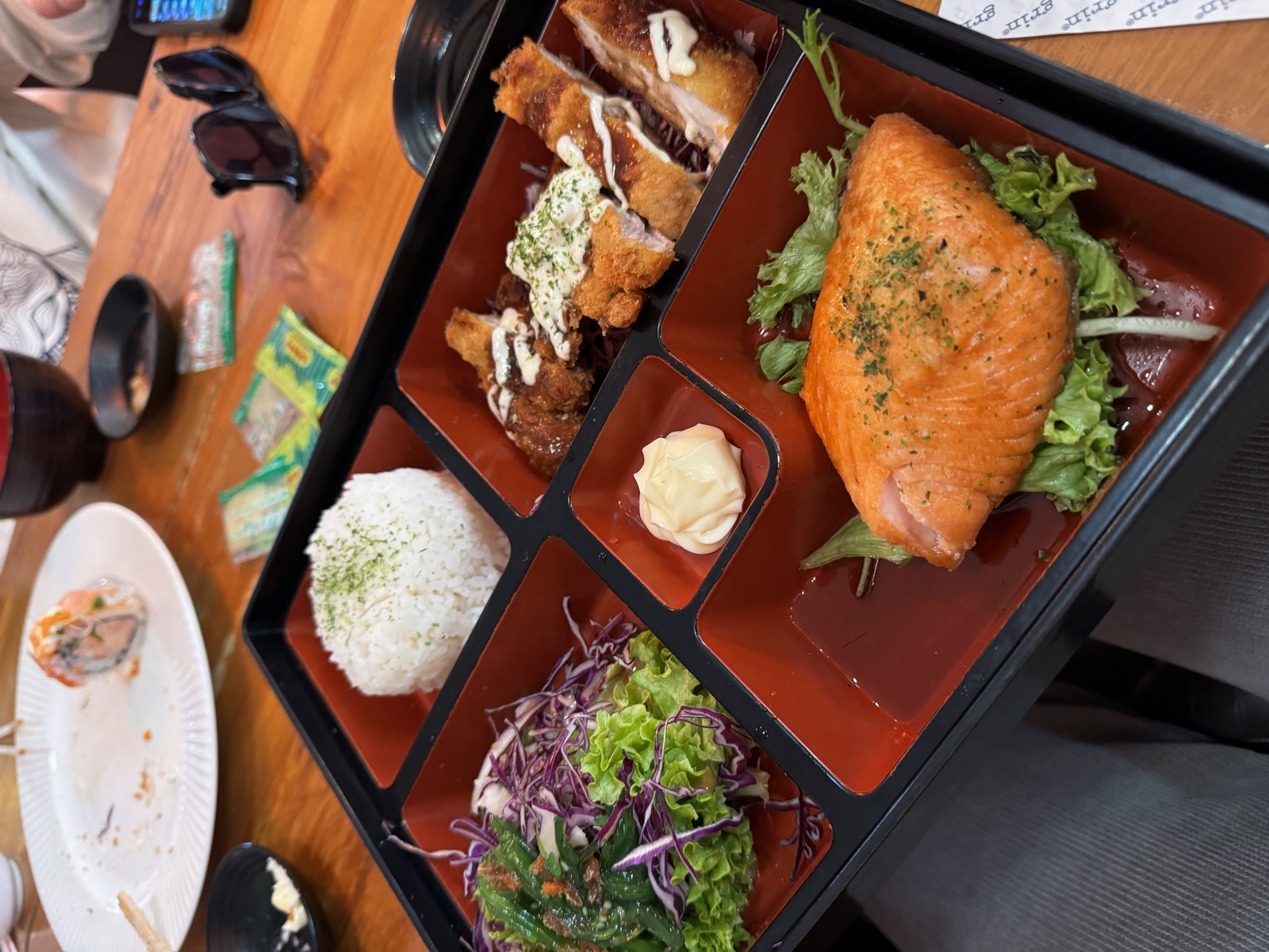 Dinner tray with rice, salmon, and small side dishes in New Plymouth