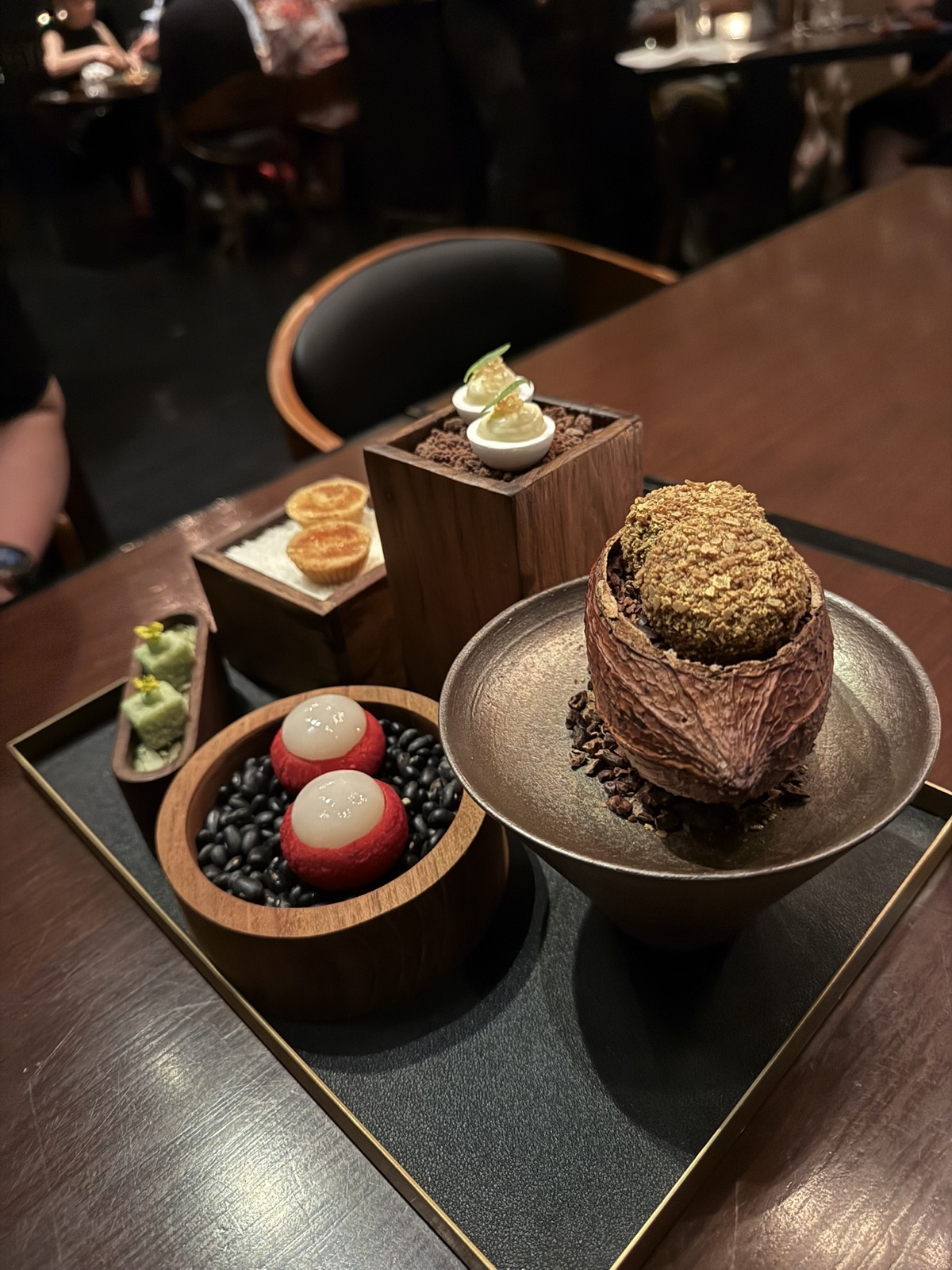 A Saawaan dessert and petit fours selection on a table