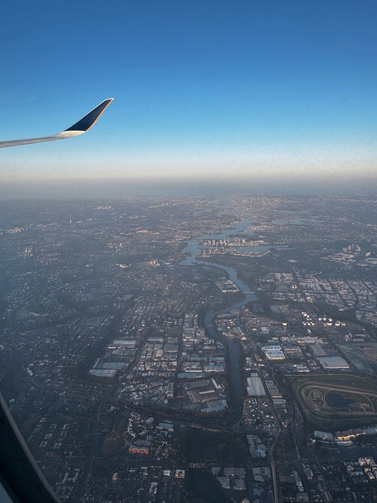 City and river seen from an aircraft window on the descent