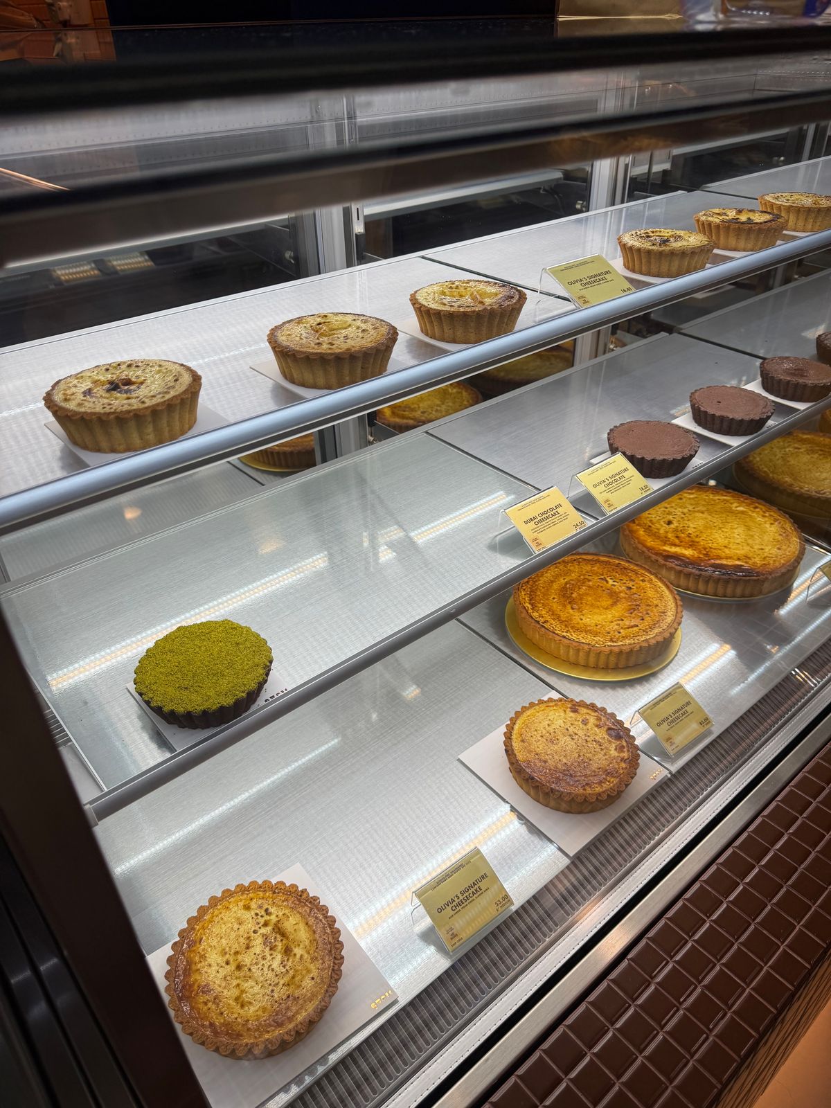 Refrigerated display of tarts and cakes in a patisserie