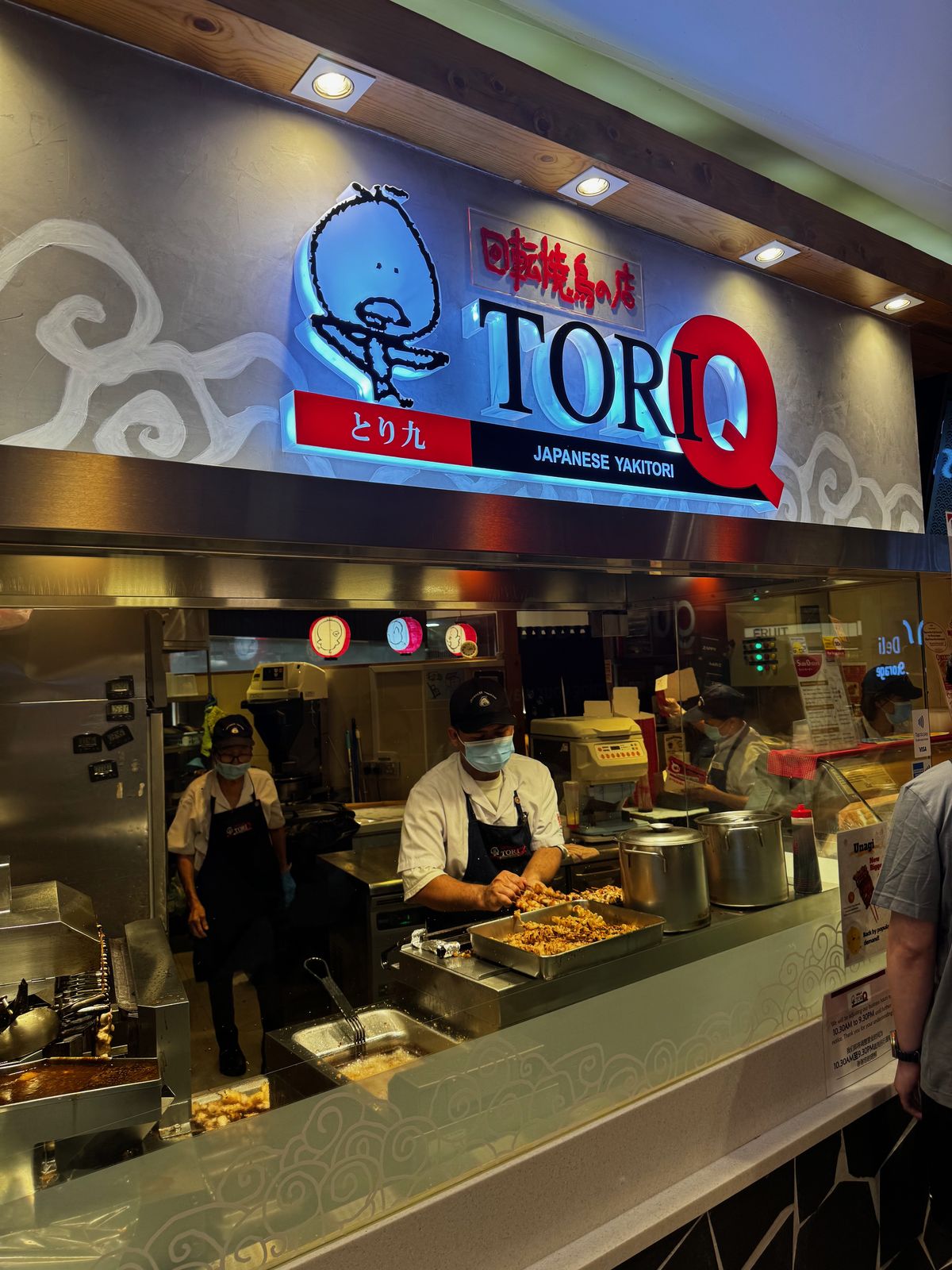 Open kitchen counter at a Japanese yakitori restaurant with cooks working