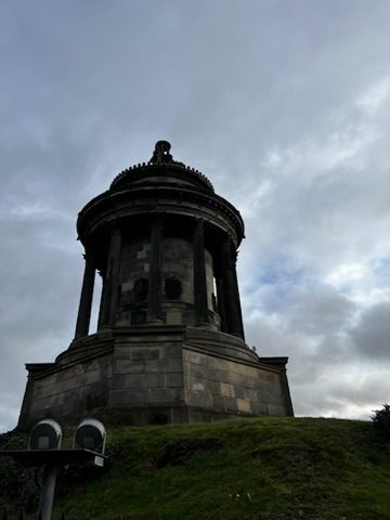 Hilltop monument in Edinburgh beneath grey clouds