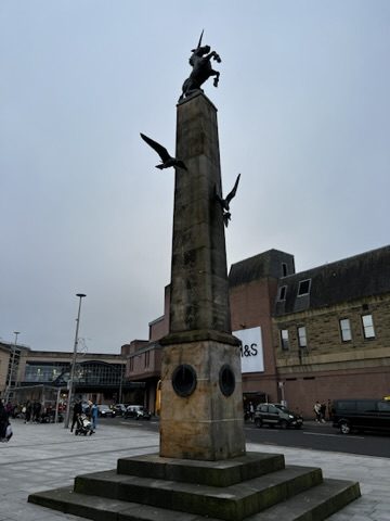 Stone monument in Inverness under grey sky