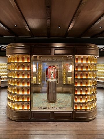 Wall of whisky barrels and bottles