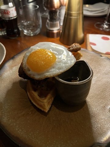 London brunch plate with egg-topped waffle